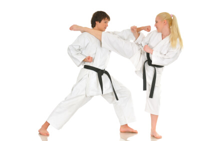 Young adult couple practicing Karate on white background, studio shot. Series. Young adult couple practicing Karate on white background, studio shot. Series.